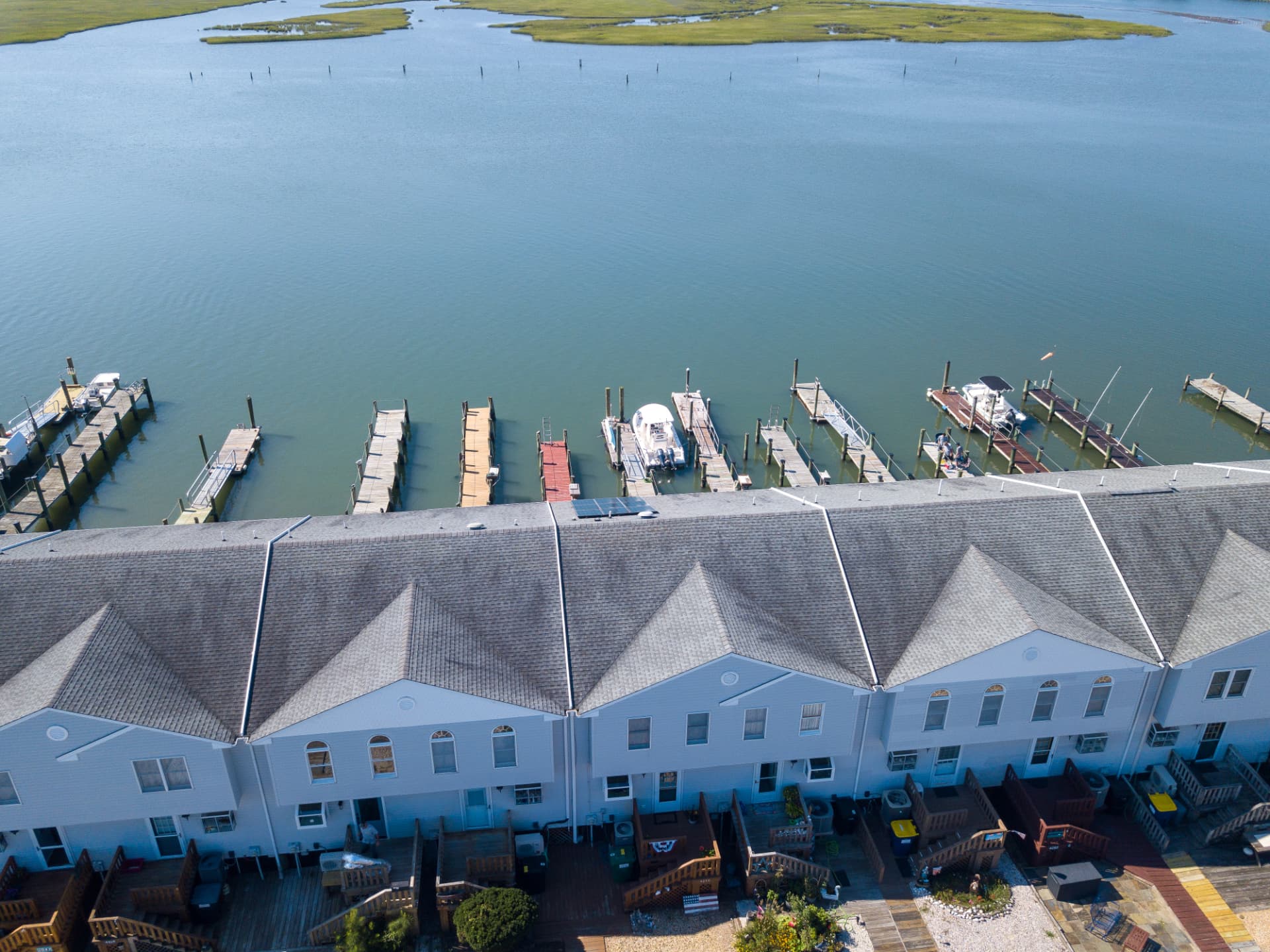 Aerial view of Channel Landing townhomes and the waterfront channel behind them